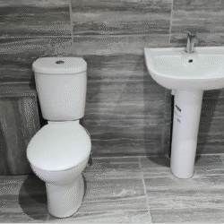 Bathroom (After): Bathroom after a thorough renovation. The installation of new boiler box, S/F new bathroom units, flooring, wall & floor tiles, and complete décor.