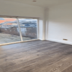 Lounge (After) - Chimney breast removed. New engineered wooden flooring fitted