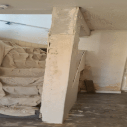 Staircase (Before): The carrier pillar before replacement (Strongboys were used as ceiling support)